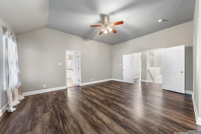 unfurnished bedroom with lofted ceiling, dark wood-style floors, and baseboards