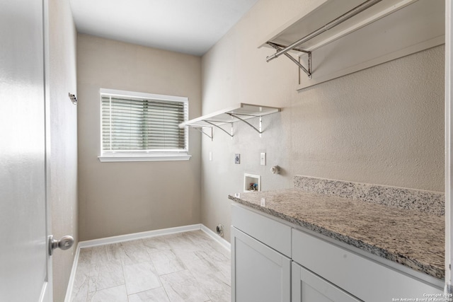 washroom featuring washer hookup, hookup for an electric dryer, cabinet space, and baseboards