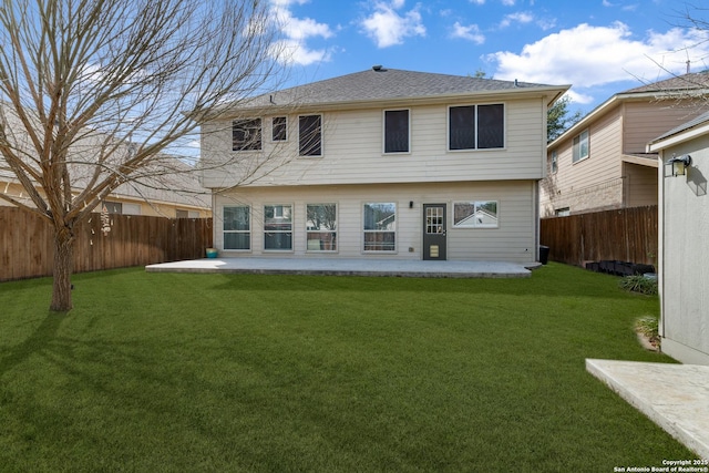 back of property featuring a patio area, a yard, and a fenced backyard