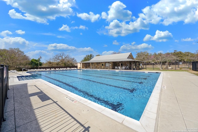 community pool featuring a patio and fence