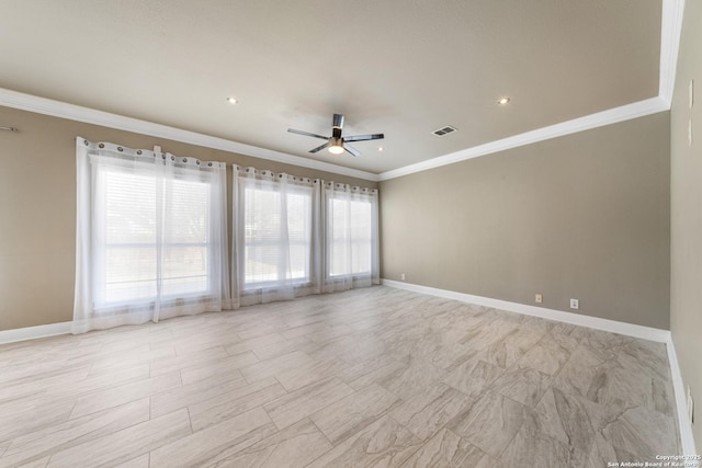 empty room featuring ornamental molding, a ceiling fan, visible vents, and baseboards