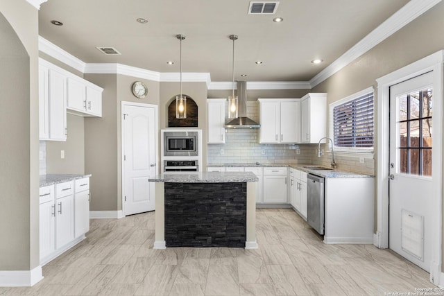 kitchen with appliances with stainless steel finishes, visible vents, a sink, and wall chimney exhaust hood