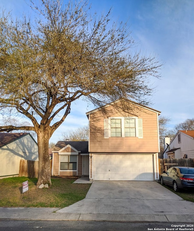 view of front facade featuring a garage, driveway, a front lawn, and fence