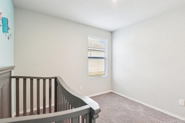 unfurnished bedroom with carpet floors and baseboards