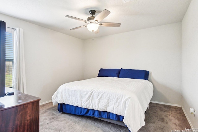 carpeted bedroom featuring a ceiling fan and baseboards