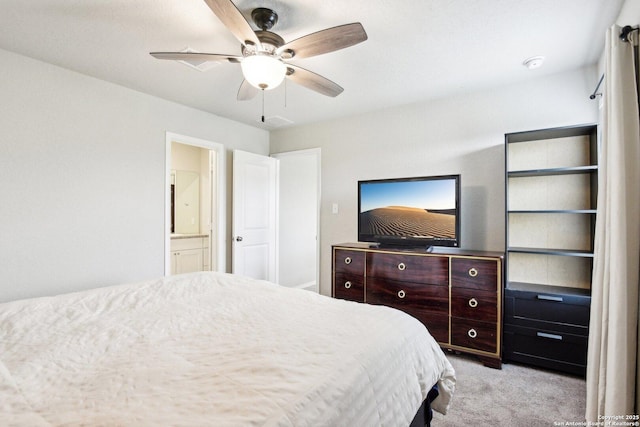 bedroom with light carpet, a ceiling fan, and connected bathroom