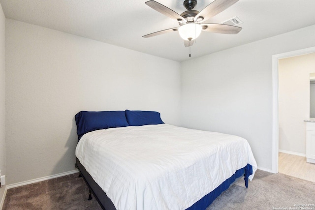 carpeted bedroom featuring a ceiling fan, visible vents, and baseboards