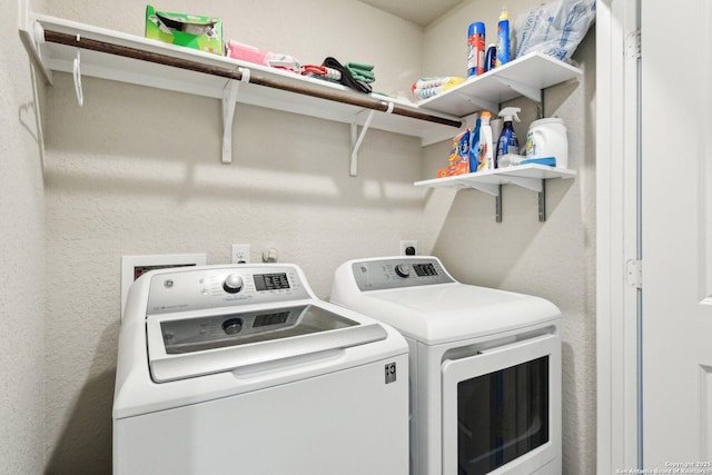 clothes washing area with laundry area and washer and dryer