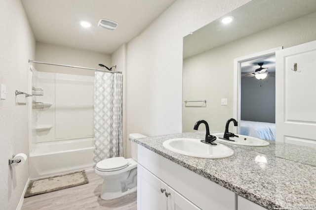 ensuite bathroom with visible vents, toilet, wood finished floors, ensuite bathroom, and vanity