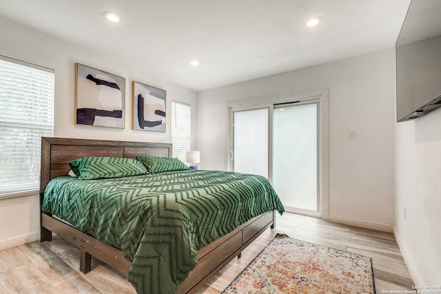 bedroom with access to outside, baseboards, wood finished floors, and recessed lighting