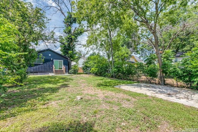 view of yard with entry steps and fence