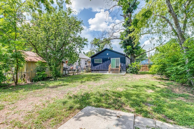 view of yard featuring entry steps and a fenced backyard