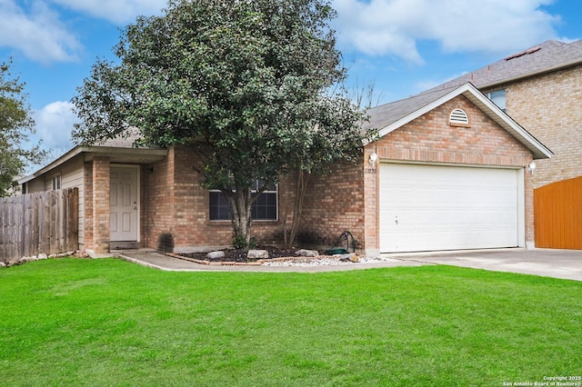 single story home with a front yard, brick siding, fence, and an attached garage