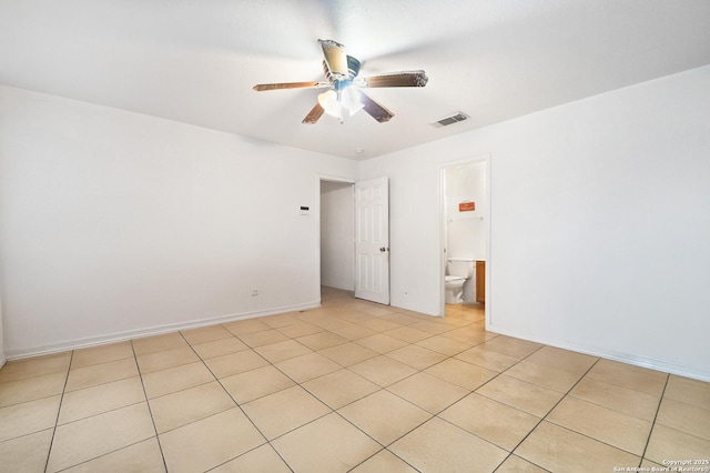 empty room with visible vents, ceiling fan, and baseboards