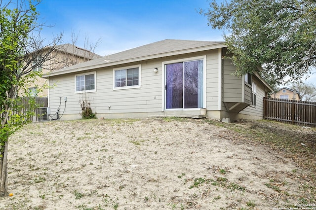 rear view of property with central AC and fence private yard