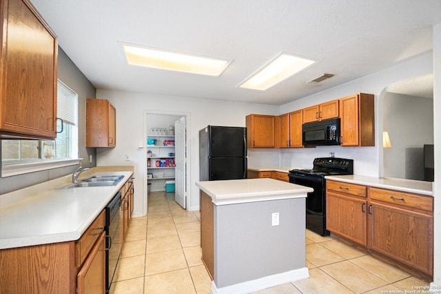 kitchen with visible vents, a sink, black appliances, and light tile patterned floors