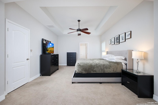 bedroom with visible vents, baseboards, a raised ceiling, light colored carpet, and ceiling fan