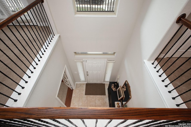 tiled entrance foyer featuring stairs