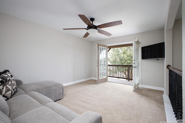 living room featuring carpet floors, ceiling fan, and baseboards