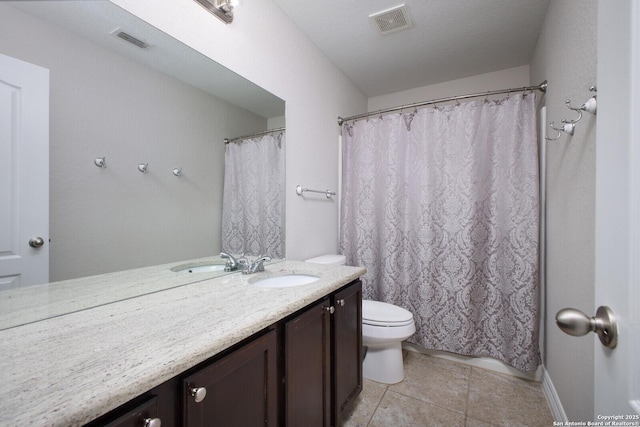 full bath featuring toilet, vanity, visible vents, and tile patterned floors