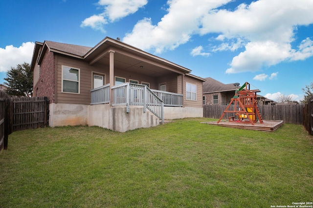 back of property featuring a fenced backyard, a playground, and a lawn