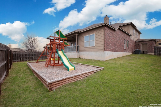 view of playground featuring a fenced backyard, central AC unit, and a yard