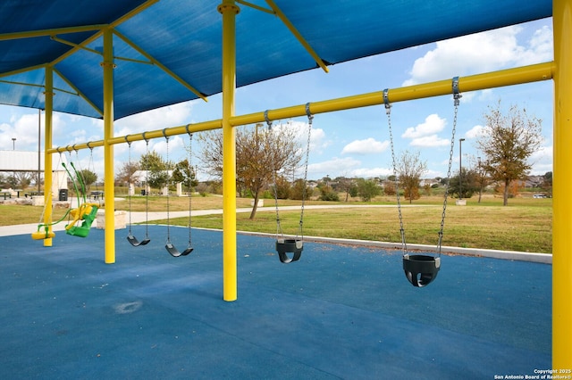 community jungle gym featuring a yard