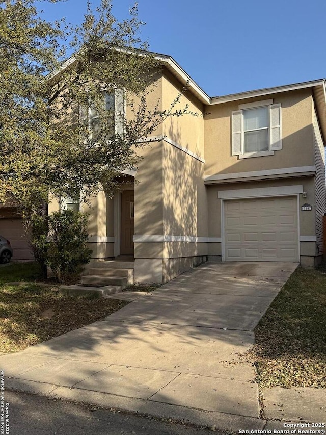 view of front of home featuring a garage, entry steps, driveway, and stucco siding