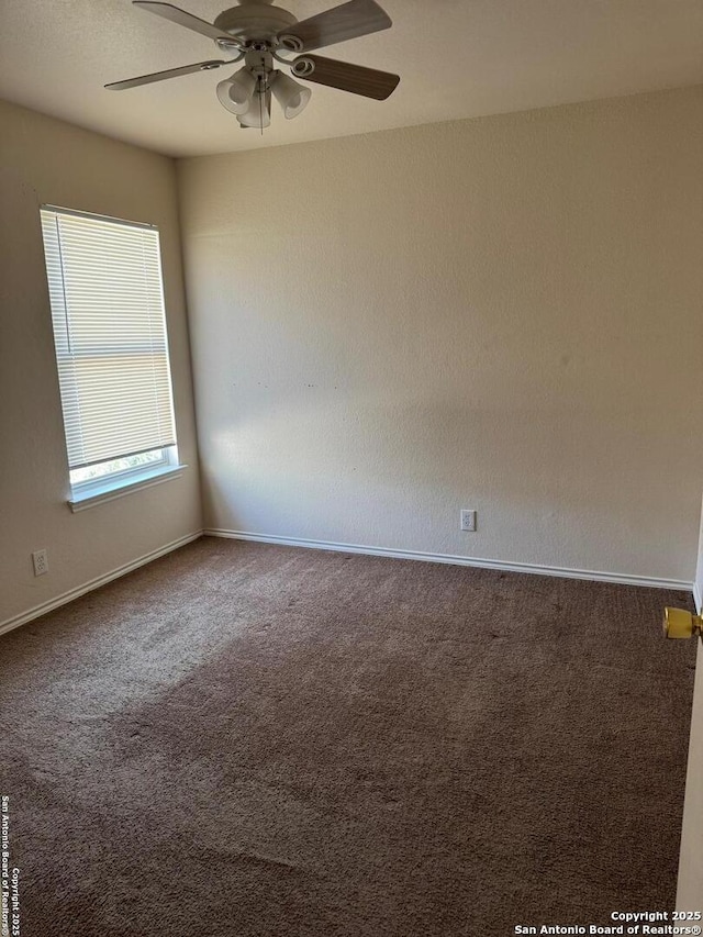 empty room with ceiling fan and carpet flooring