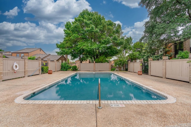 view of swimming pool featuring a fenced in pool, a patio area, and fence