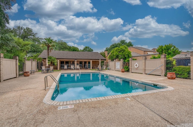 community pool featuring a patio and fence