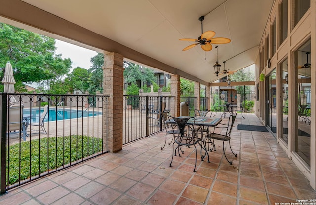 view of patio with fence, a ceiling fan, and a fenced in pool