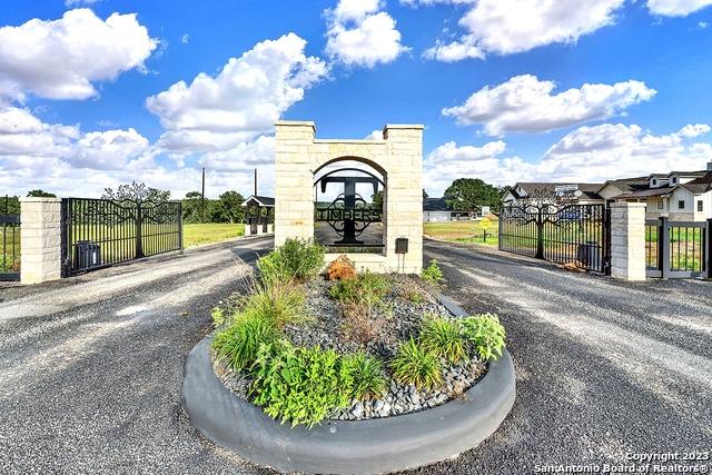 view of road with a gate and a gated entry