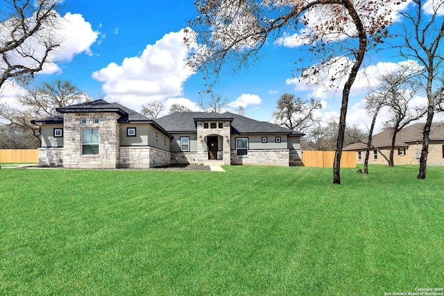 view of front of house with fence, stone siding, stucco siding, a chimney, and a front yard