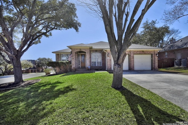 ranch-style home with concrete driveway, brick siding, an attached garage, and a front yard