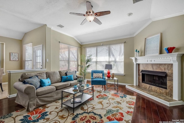 living room with lofted ceiling, plenty of natural light, visible vents, and wood finished floors