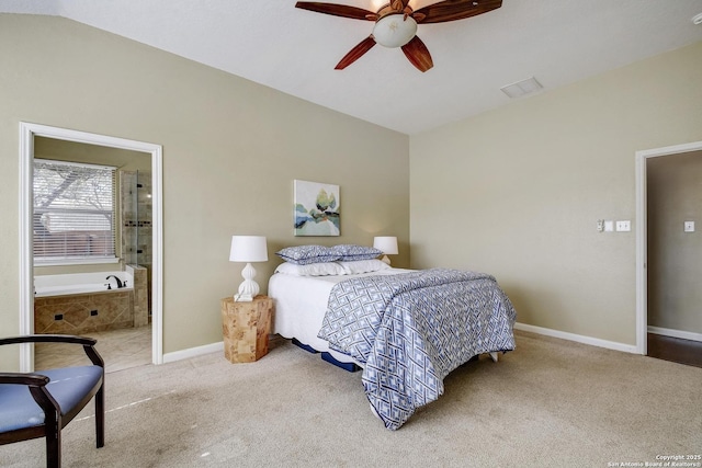 carpeted bedroom with visible vents, baseboards, lofted ceiling, ceiling fan, and ensuite bathroom