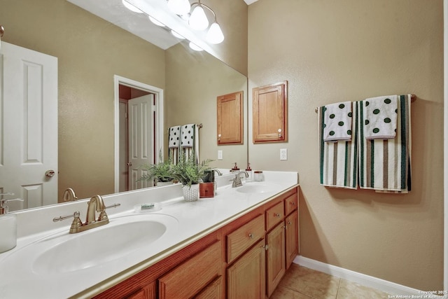 full bath featuring tile patterned flooring, a sink, baseboards, and double vanity