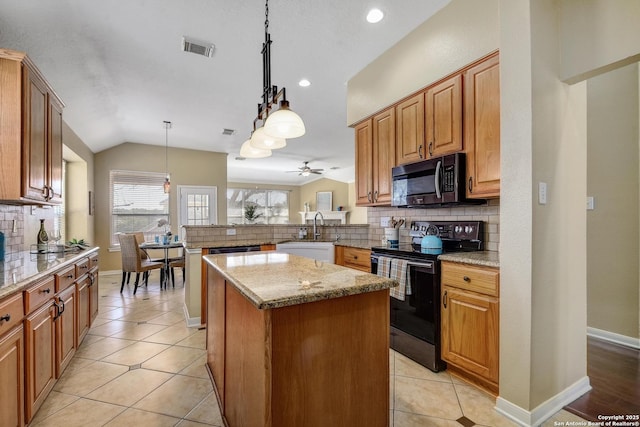 kitchen featuring black electric range oven, visible vents, vaulted ceiling, a sink, and a peninsula