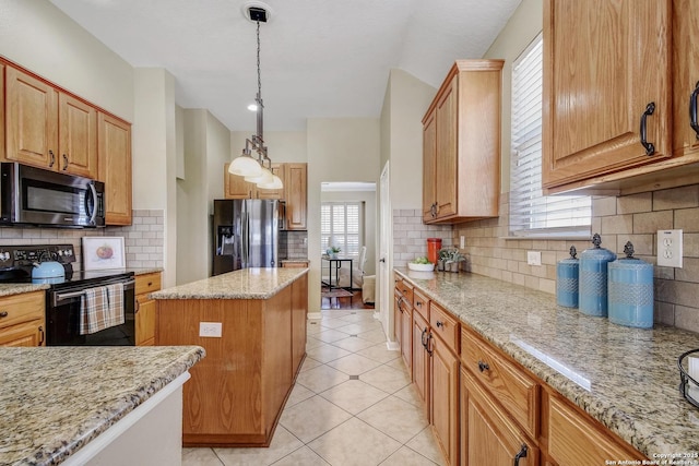 kitchen featuring light tile patterned floors, light stone counters, black range with electric cooktop, a kitchen island, and stainless steel fridge with ice dispenser