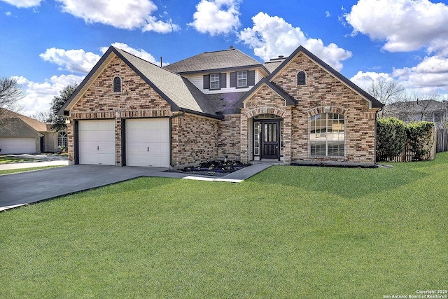 view of front facade with a garage, a front yard, concrete driveway, and brick siding