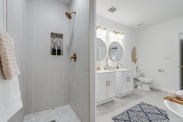 bathroom featuring baseboards, visible vents, tiled shower, toilet, and vanity