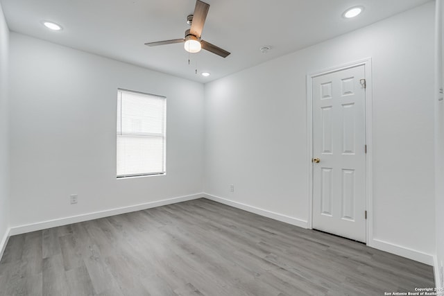 spare room with recessed lighting, ceiling fan, baseboards, and wood finished floors