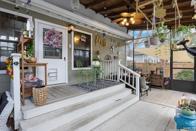 doorway to property featuring fence, a porch, and log exterior