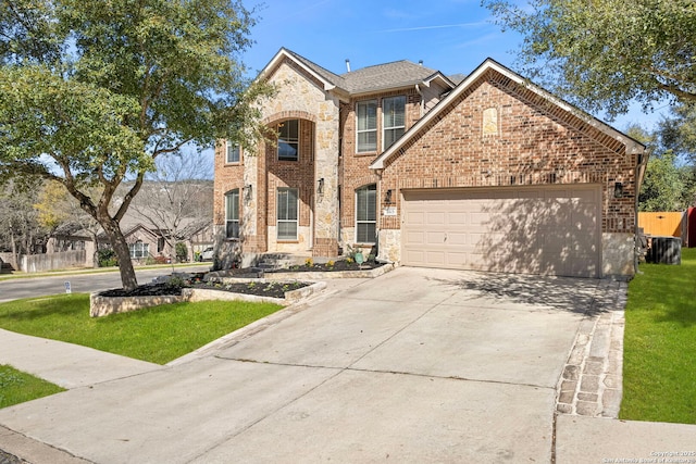 view of front of home featuring an attached garage, brick siding, concrete driveway, stone siding, and a front lawn