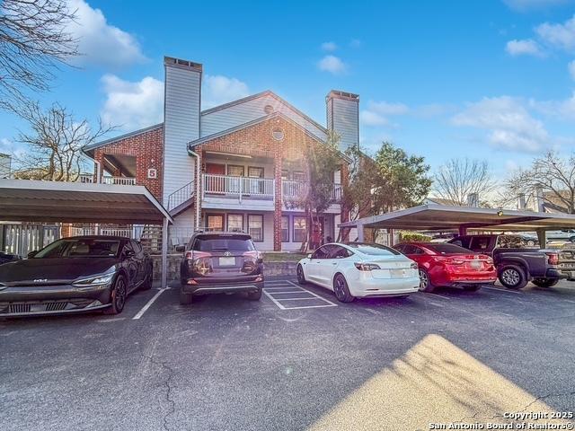 view of partially covered parking lot