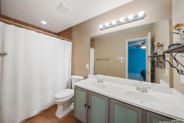 bathroom featuring visible vents, toilet, a sink, a textured ceiling, and tile patterned flooring