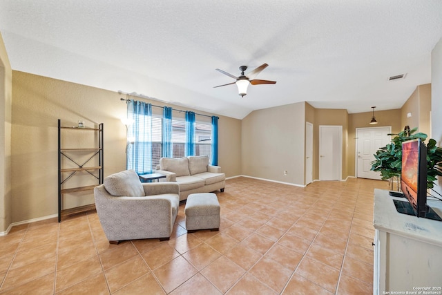 living area with light tile patterned floors, a textured ceiling, visible vents, and a ceiling fan