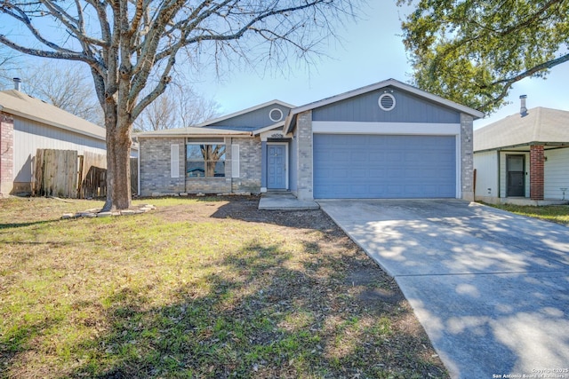 ranch-style home with a front yard, concrete driveway, fence, and an attached garage