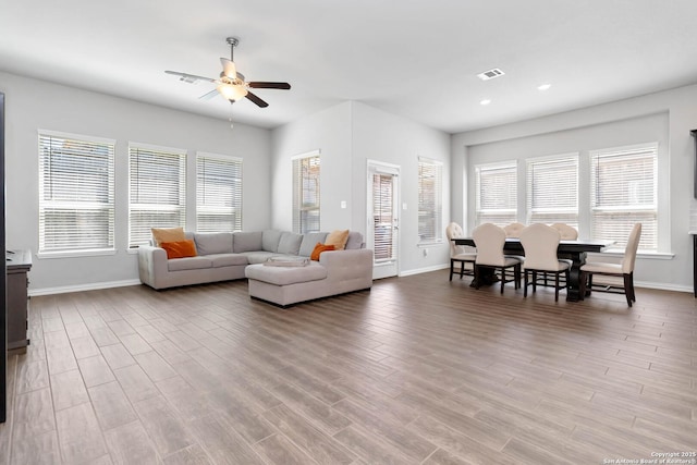 living room featuring recessed lighting, visible vents, a ceiling fan, wood finished floors, and baseboards